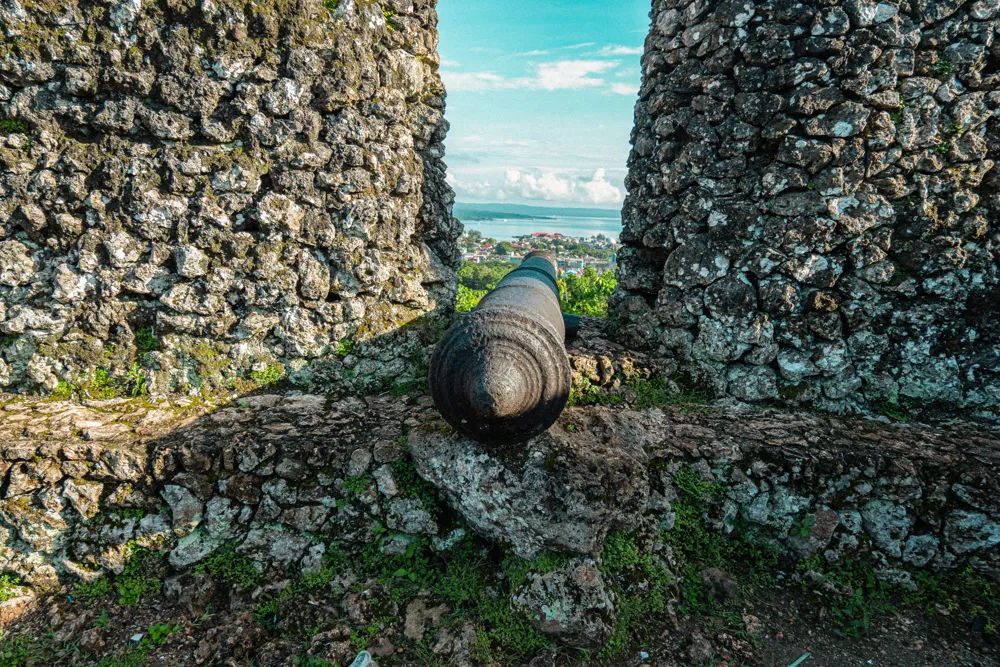 An old cannon in a fortress wall above the town.