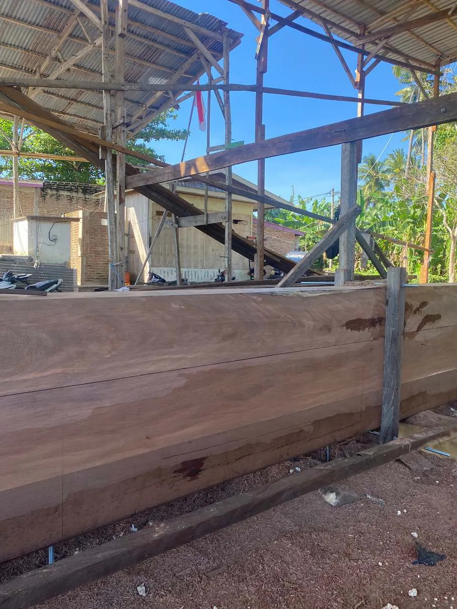 The large keel timbers standing in the shipyard shed