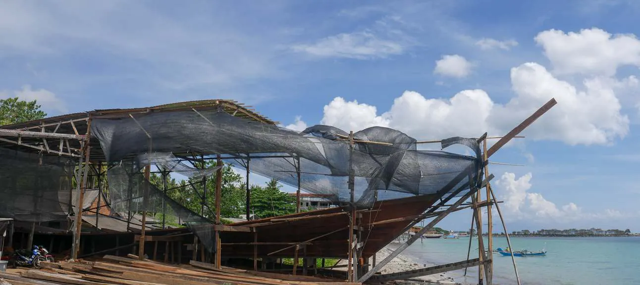 The WAOW 2 hull under shade netting at the seaside shipyard