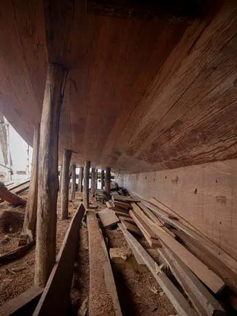 Underneath the planked hull among the supports