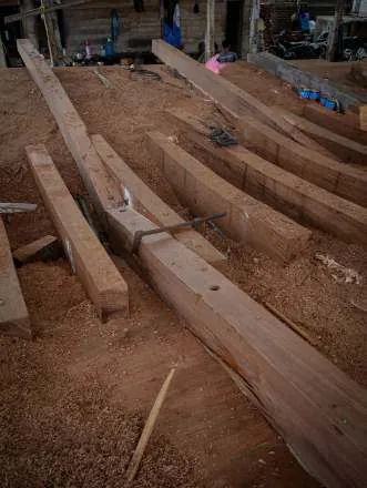 Heavy timbers lying on the shipyard floor