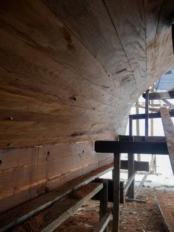 The curved planked side of the hull