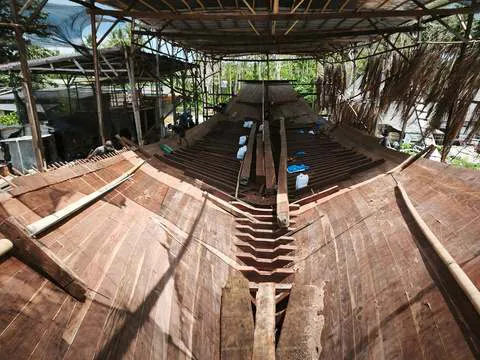 Looking down the length of the hull inside the building shed
