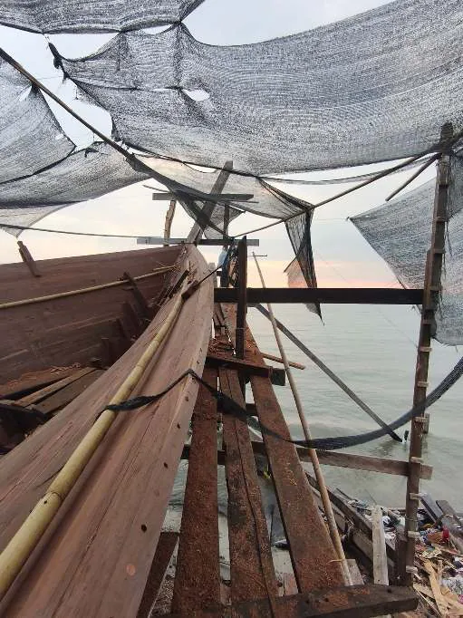 The bow planking under shade nets at dusk
