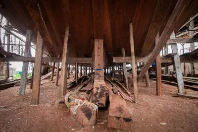 Underneath the hull, propped on wooden supports