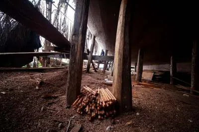 Stacked wooden pegs among the supports beneath the hull