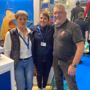Two women and a man at the WAOW 2 booth