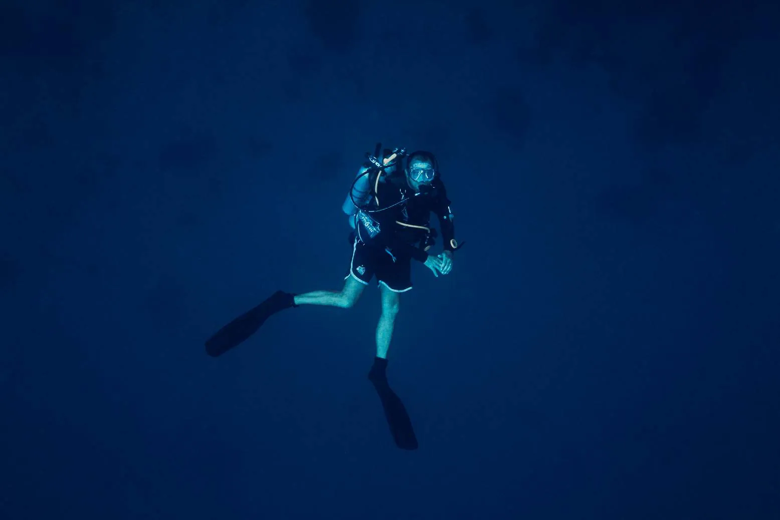 A diver hovering in deep blue water