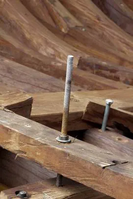 A large bolt passing through a rib into the keel structure