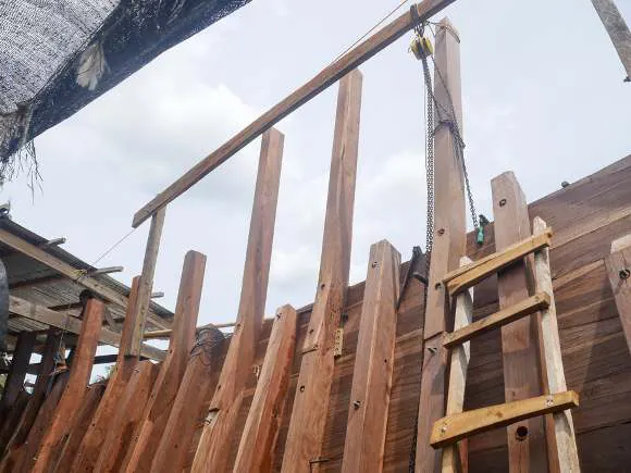 The rising bow structure with a wooden ladder against the sky