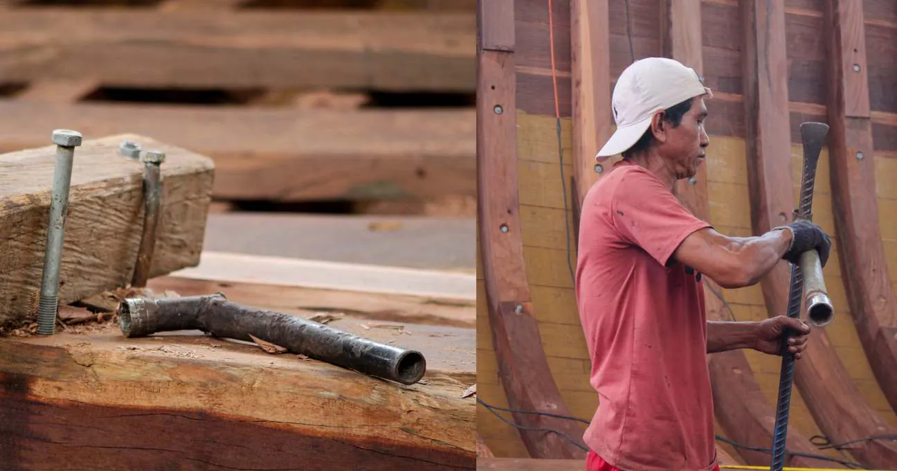 A shipbuilder tightening a bolt with a long wrench, bolts and spanner on a beam