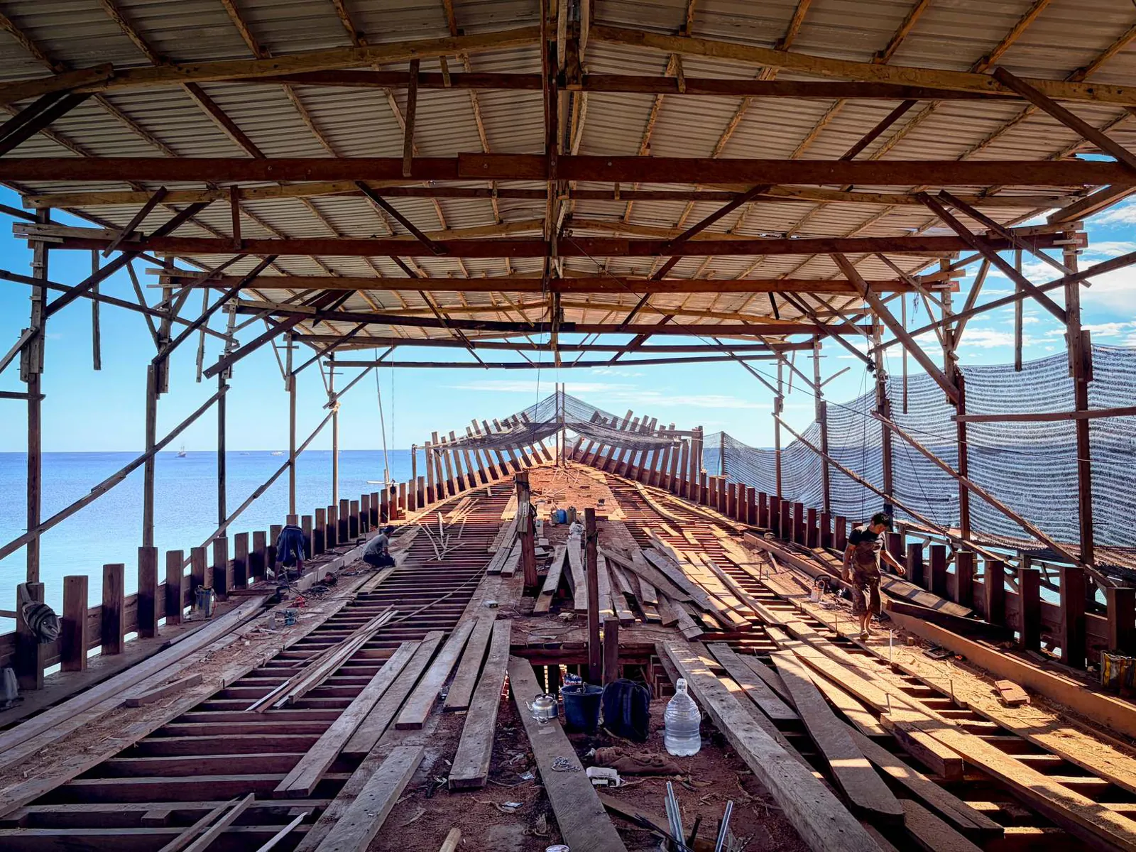The main deck of WAOW 2 taking shape under the shipyard roof, with the sea in the background