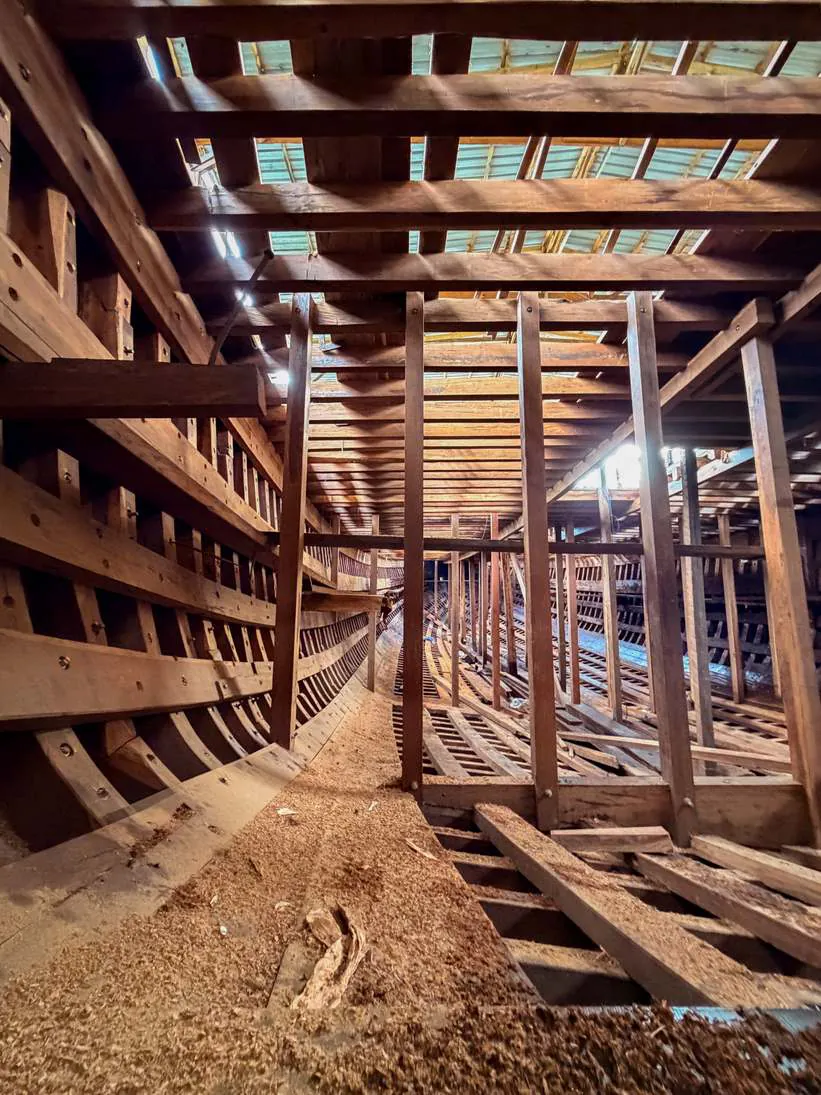 The space below the main deck, with beams overhead and frames along the hull