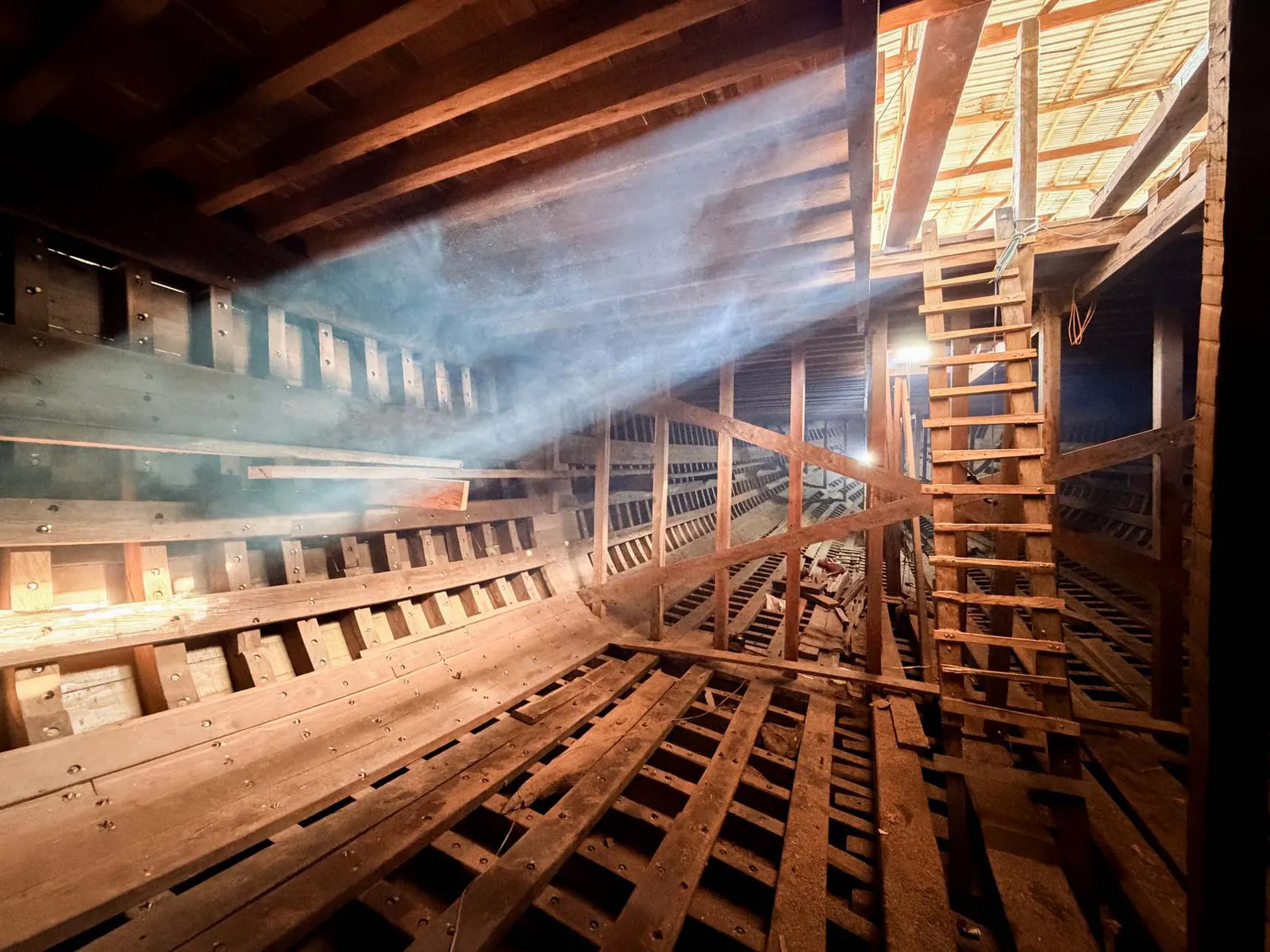 Sunlight streaming through the deck openings into the hull of WAOW 2