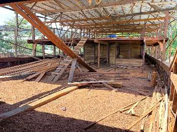 The upper deck under construction beneath the shipyard roof