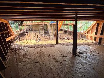 Interior of the main deck with posts and sawdust on the floor