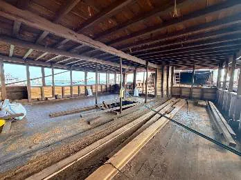 A long open space on the main deck with windows along the side