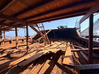 The main deck under the upper deck, with planks and a ladder