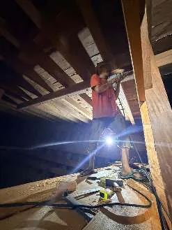A craftsman working with a lamp in the lower deck