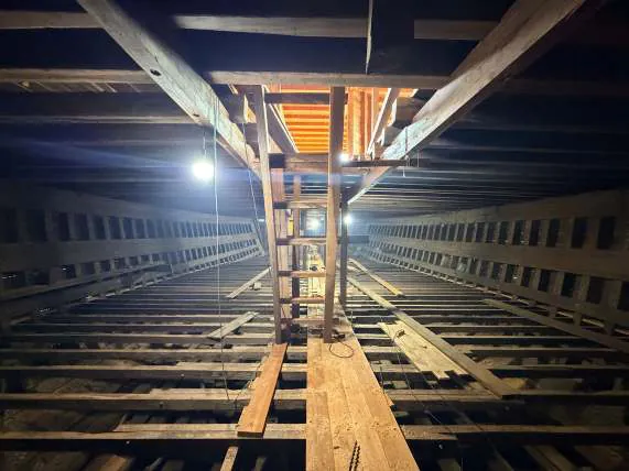 The lower deck seen lengthwise, with posts and a lit opening above