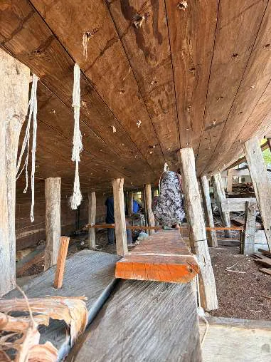 Caulking cords hanging from the seams under the hull