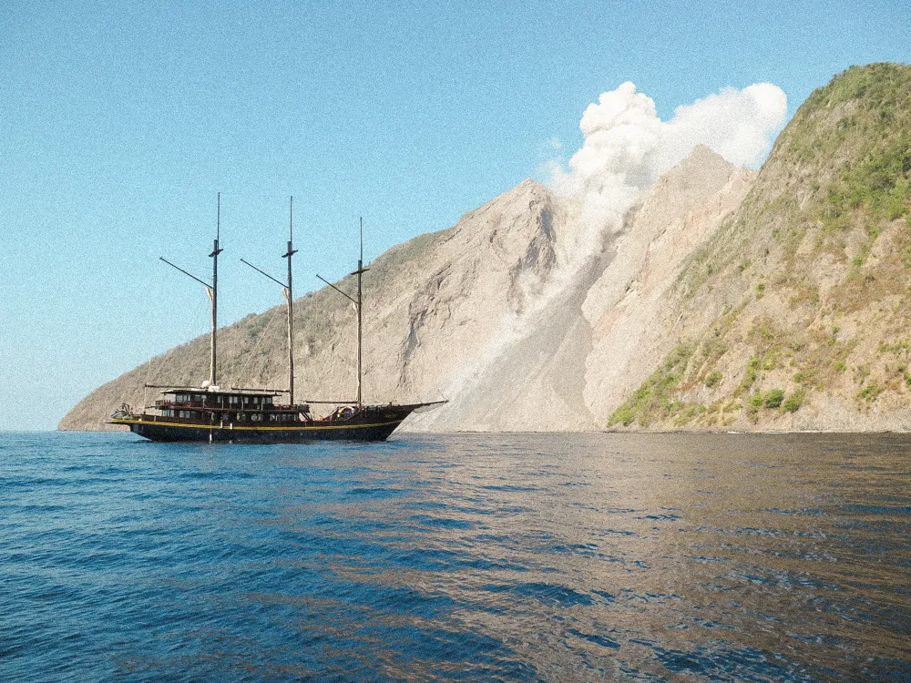 WAOW anchored below a smoking volcano.
